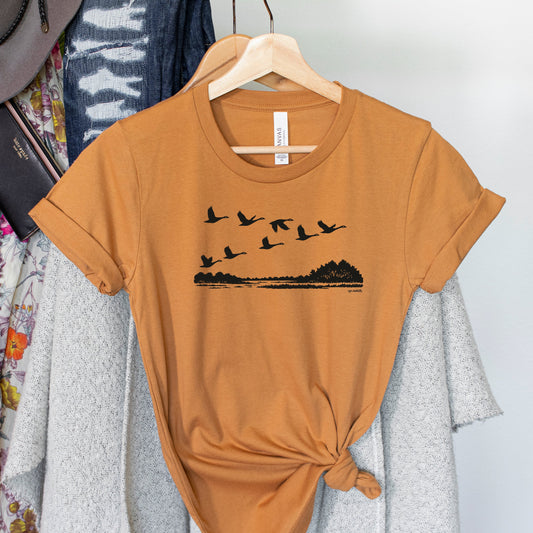 Migration Adult Crewneck Unisex Tee. Rust.